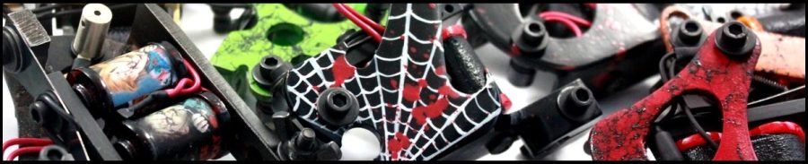 Colorful tattoo machine parts with spider web.