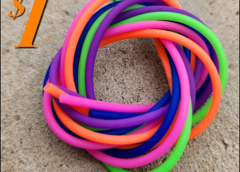 Colorful neon bracelets on textured surface.