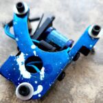 Close-up of a worn blue mechanical part with bolts.