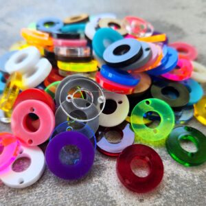 Colorful plastic spools with thread in various bright colors.