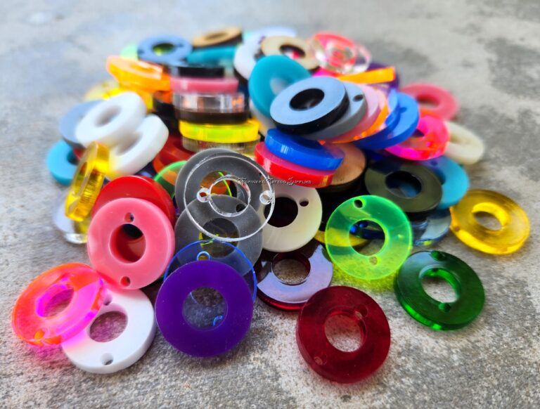 Colorful plastic spools with thread in various bright colors.