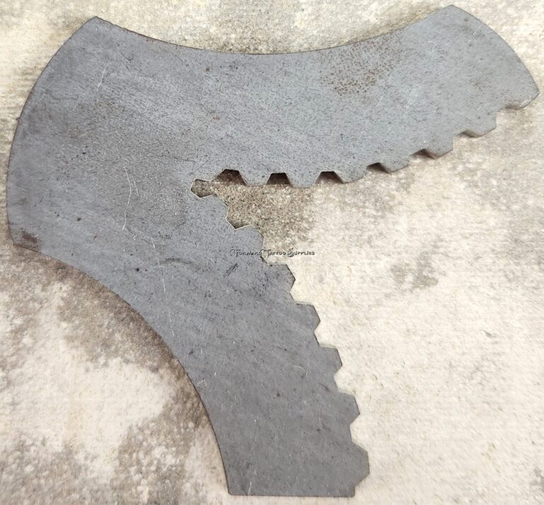 Metal gear-like object on textured surface.