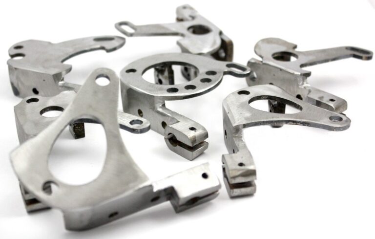 Metal components scattered on white background.