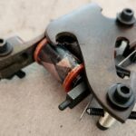 Worn metal armature with exposed screw