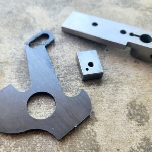 Metal machine parts on textured surface.