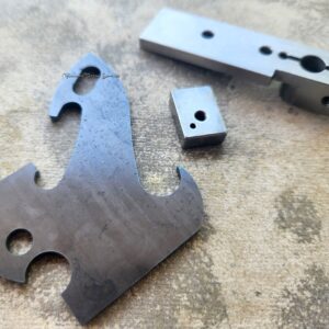 Metal machine parts on textured surface.