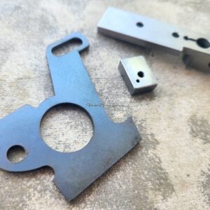 Metal machine parts on textured surface.