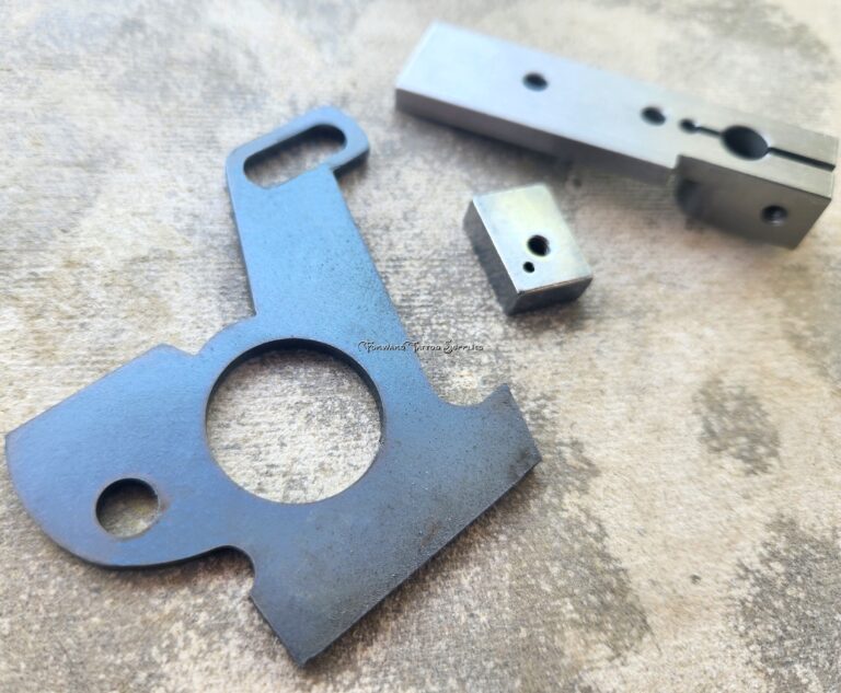 Metal machine parts on textured surface.