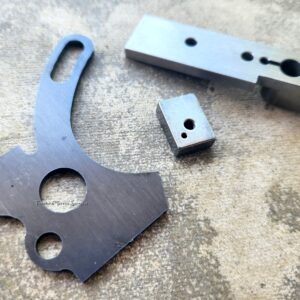 Metal machine parts on textured surface.