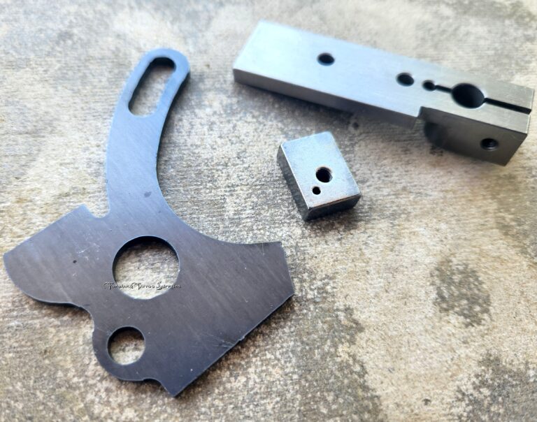 Metal machine parts on textured surface.