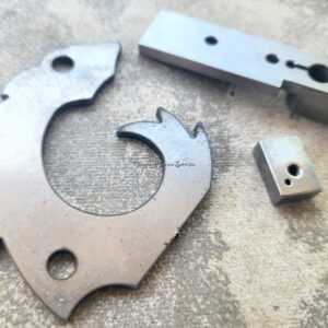Metal machine parts on textured surface.