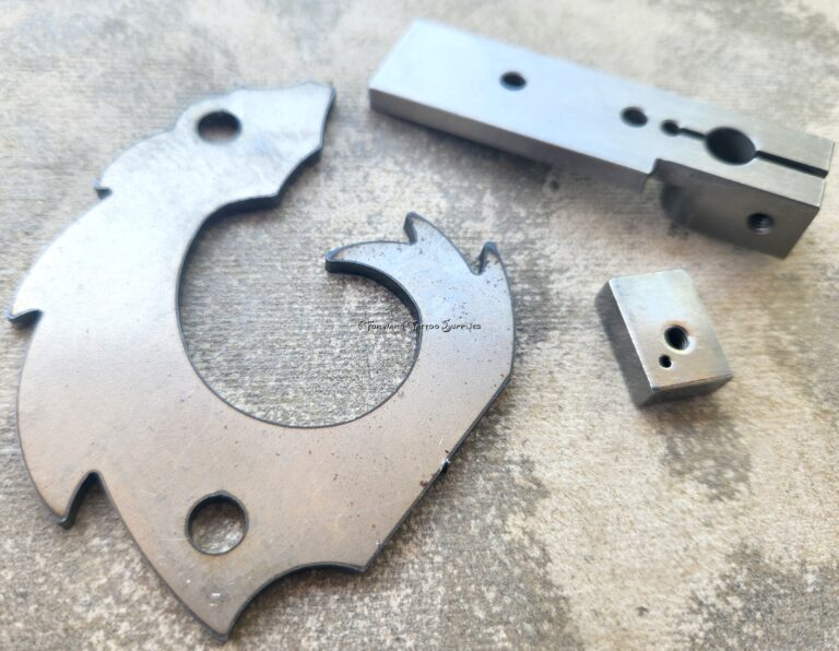 Metal machine parts on textured surface.
