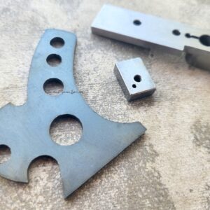 Metal components with various holes and shapes.