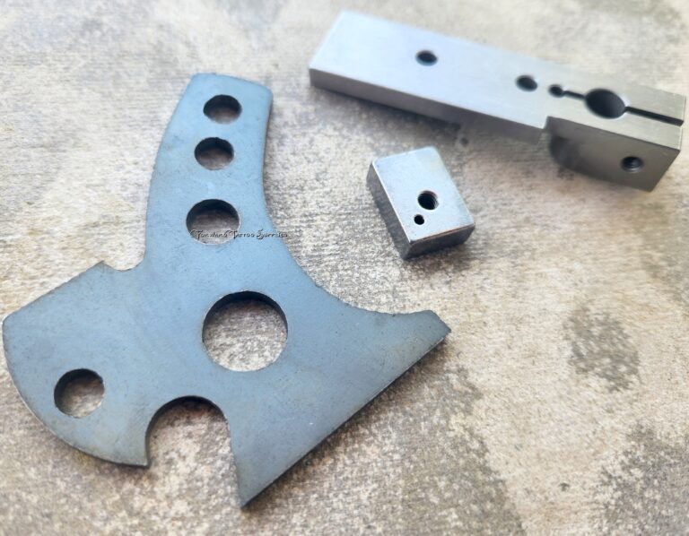 Metal components with various holes and shapes.