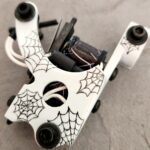 White rotary tattoo machine with spiderweb art