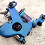 Iridescent blue tattoo frame with colorful grip