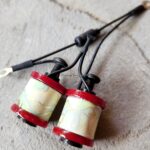 Two small coils with red ends connected by wires.