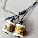 Vintage tattoo machine keychains with intricate designs.