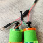 Close-up of colorful electronic components with wires and screws.