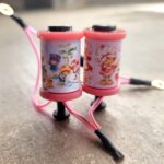 Two pink children's jump ropes with cartoon character handles.