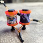 Close-up of two colorful toy lanterns with cartoon characters.