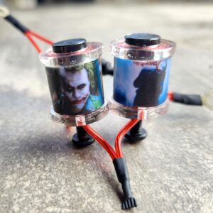 Two custom drone motors with images of faces on them.