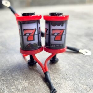 Close-up of a slot machine showing two red sevens in a row.