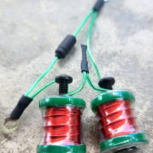 Two small coils of red wire wrapped on green spools with attached green wires.