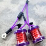 Two purple coils with red wire wrapped around them, connected by purple wires.