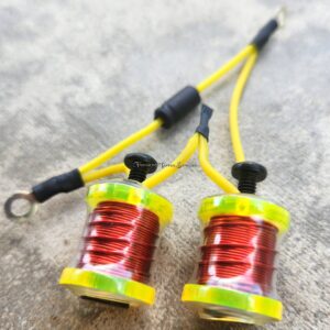 Close-up of two yellow and red electrical coils with connecting wires.