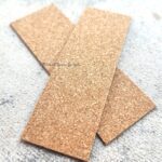 Three rectangular cork sheets overlapping on a white surface.