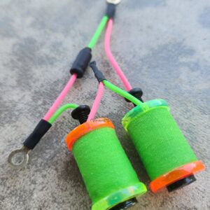 Two neon green and pink fishing lines with bright green spools.