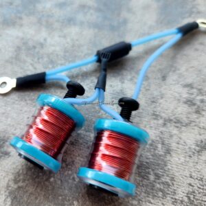 Close-up of two blue electrical coils with red wire.
