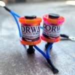 Close-up of two colorful wristbands with the text 'ORW' and adjustable straps.