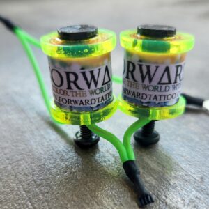 Two vibrant green and yellow fishing reels with Orwar branding on a wooden surface.