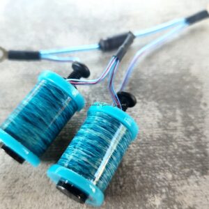Two blue coil inductors with connecting wires on a surface.