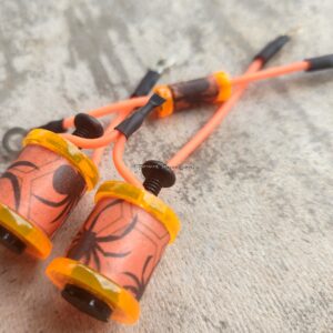 A vibrant pair of orange and yellow decorative bells with intricate designs.