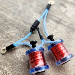 Two small blue coils wrapped with red wire connected by blue wires.