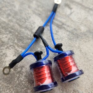 Two blue and red electrical coils with black connectors on a gray surface.