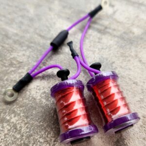 Close-up of purple and red coil components with wires.