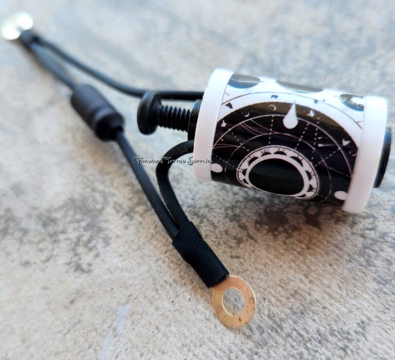 Close-up of an electrical cable with a ring terminal on a concrete surface.