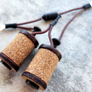A pair of binoculars wrapped with cork material.
