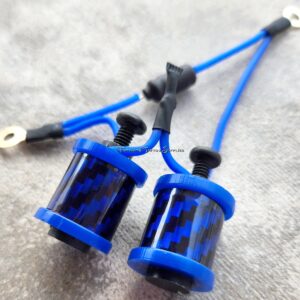 Close-up of blue cylindrical components with wires on a textured surface.