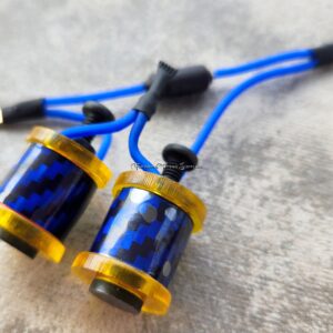 Close-up of blue and gold tattoo machine coils on a gray surface.