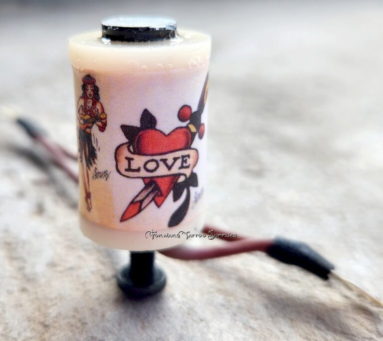 A tattoo machine with a love-themed design on its grip.