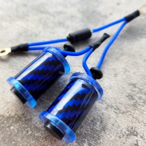 Close-up of two blue carbon fiber earphones with braided cables on a grey surface.