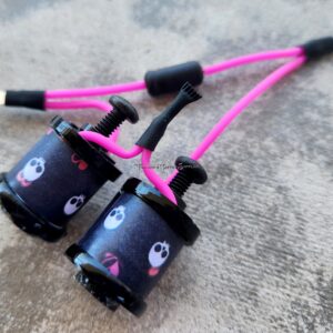 Close-up of black and pink mechanical components with cables.