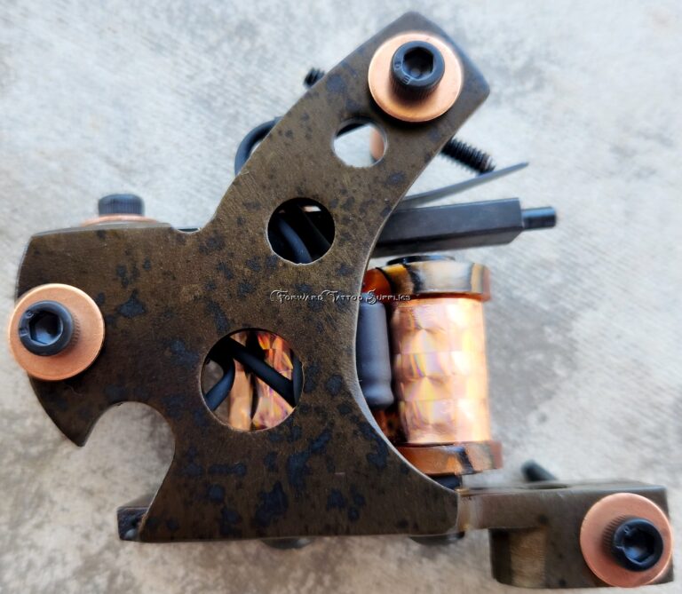 Close-up of a rusty tattoo machine with copper coils.