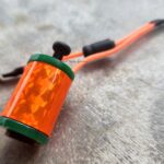 Close-up orange tattoo machine grip
