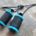 Tattoo machine coils with turquoise rubber caps
